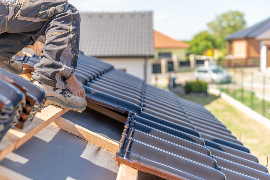 worker installing roof tile